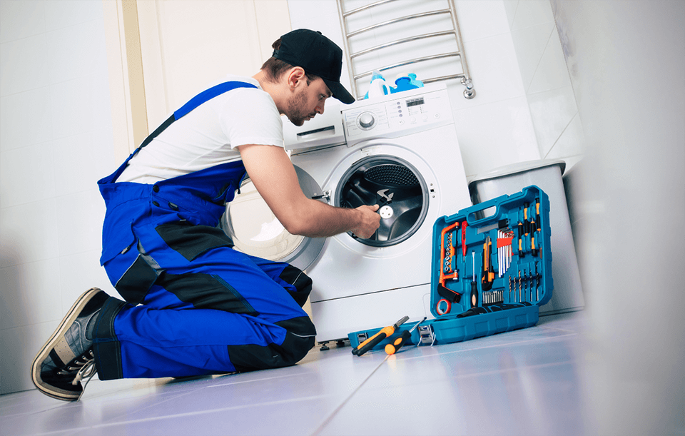Professional washing machine repair technician servicing a modern washing machine in Dubai home